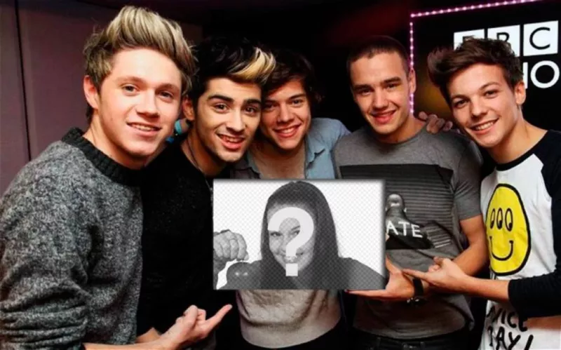 One Direction are your biggest fans, evidenced by holding your picture in this photo..